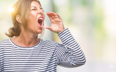 Poster - Middle age senior hispanic woman over isolated background shouting and screaming loud to side with hand on mouth. Communication concept.