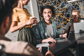 Wall Mural - cropped shot of business colleagues having meeting at table with laptops in modern office