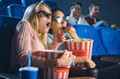 © LIGHTFIELD STUDIOS - shocked multiracial women in 3d glasses with popcorn watching film together in movie theater