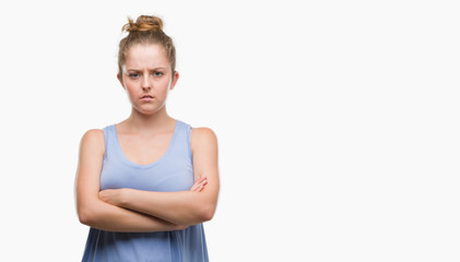 Wall Mural - Young blonde woman skeptic and nervous, disapproving expression on face with crossed arms. Negative person.