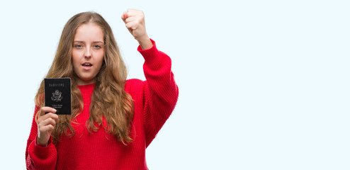 Poster - Young blonde woman holding passport of United States of America annoyed and frustrated shouting with anger, crazy and yelling with raised hand, anger concept