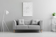 © Photographee.eu - White lamp next to grey couch in minimal living room interior with poster and plant. Real photo