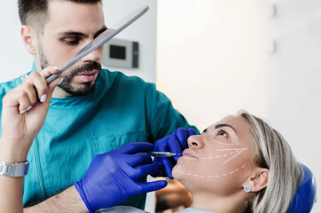 Wall Mural - Male doctor doing botox on patient