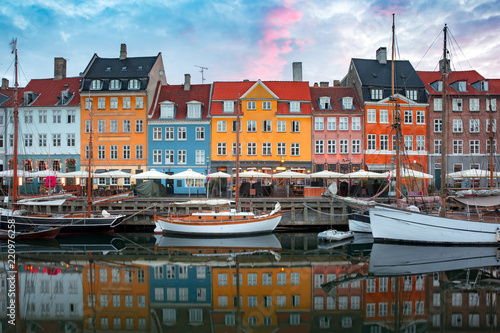 Nyhavn at sunrise, with colorful facades of old houses and old ships in the Old Town of Copenhagen, capital of Denmark Wallpaper Mural
