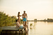 © BGStock72 - Group of young people having fun on pier at the lake