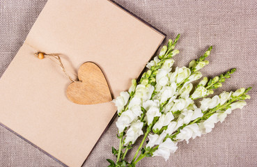 Wall Mural - bouquet and heart. Wooden heart and white flowers. St. Valentine's Day. Open book. Romantic background