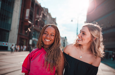 Wall Mural - Happy female friends hangout at city street, multi ethnic group of people