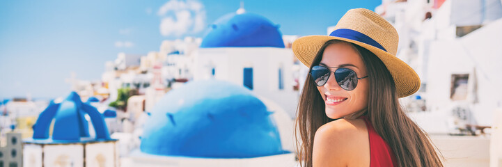 Fototapete - Summer travel tourist girl smiling on Santorini Europe holiday. Vacation panoramic banner landscape on the three blue domes.