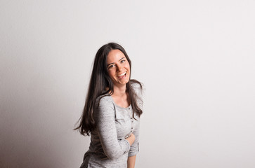 Wall Mural - Portrait of a young beautiful woman in studio on a white background.