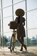 © mikitiger - cute girl in hat is traveling on a retro bike outdoors in a city in summer