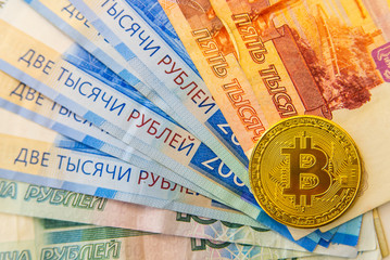 Wall Mural - Golden Bitcoin cryptocurrency on Euro and Rubles banknotes. New virtual money concept