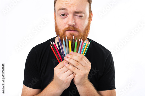 Fotografia, Obraz Crop bearded redhead man holding colored pencils and looking at camera isolated