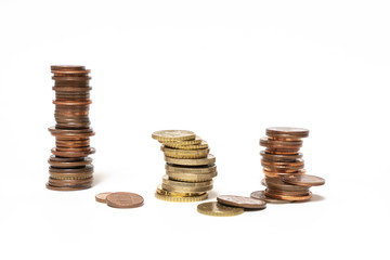 some stacked euro coins on a white surface