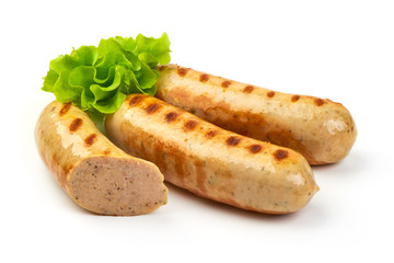 Wall Mural - Grilled Bavarian sausages with green lettuce, isolated on white background.