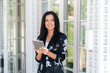 © romannoru - A close-up of the European smiles broadly, watched an interesting video on the Internet, calls her friend, wants to show her a video on the tablet. The concept of technology, gadgets, people.
