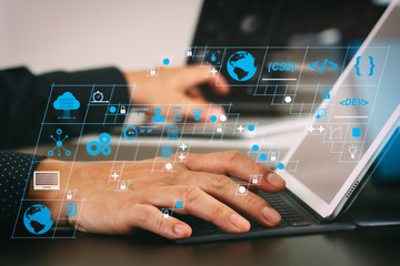 Wall Mural - close up of businessman hand working with laptop and digital docking keyboard tablet computer in mod