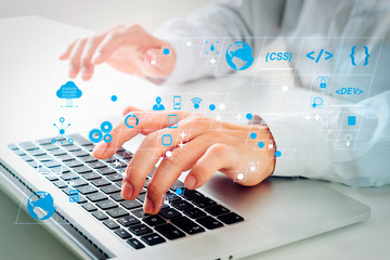 Poster - close up of businessman typing keyboard with laptop computer on white desk in modern office