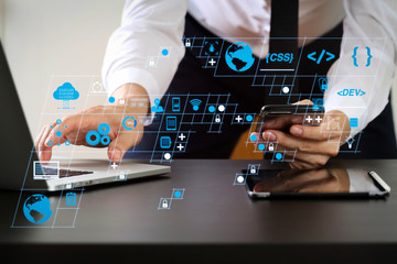 Poster - close up of businessman working with smart phone and laptop and digital tablet computer in modern office