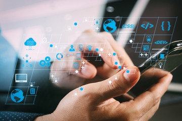 Fototapete - close up of businessman hand working with smart phone and laptop and digital tablet computer in modern office