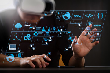 Fototapete - businessman wearing virtual reality goggles in modern office with Smartphone using with VR headset