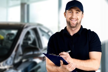 Wall Mural - Delivery man with clipboard on light background