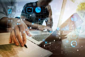 Poster - business documents on office table with smart phone and laptop and two colleagues discussing data in the background