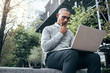 © Jacob Lund - Businessman working on laptop computer sitting outdoors