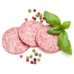 Wall Mural - Salami smoked sausage three slices, basil leaves and peppercorns isolated on white background cutout