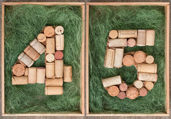 Wall Mural - Number 45 forty five  made of wine corks on green background in wooden box