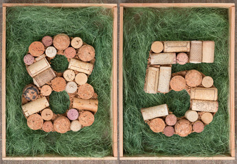 Wall Mural - Number 85  eighty five made of wine corks on green background in wooden box