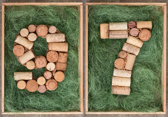 Wall Mural - Number 97 ninety seven  made of wine corks on green background in wooden box