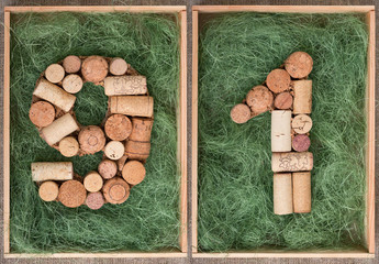 Wall Mural - Number 91 ninety one made of wine corks on green background in wooden box