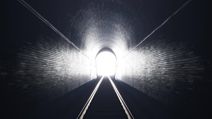 train leaving an old underground tunnel. train driver perspective. bright light.