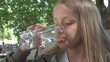 © CreativeZone - Child Drinking Water at Restaurant, Kid Holding a Glass of Water, Girl Smiling
