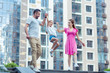 © zinkevych - Playful child. Happy nice girl jumping while holding her parents hands
