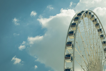 Wall Mural - Vintage White big Ferris wheel  with blue sky sharp clouds