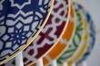 Colorful porcelain plates on the cupboard