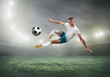 © Andrii IURLOV - Soccer player on a football field in dynamic action at summer day