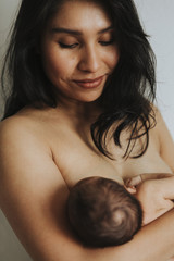 Wall Mural - naked mother holding her newborn baby