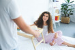 © LIGHTFIELD STUDIOS - cropped shot of man holding tray with breakfast while smiling girlfriend sitting in bed