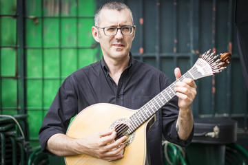 Wall Mural - Musician with his beloved unique portuguese guitar, Portugal