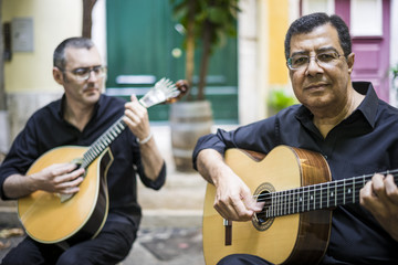 Wall Mural - Two fado guitarists with acoustic and portuguese guitars