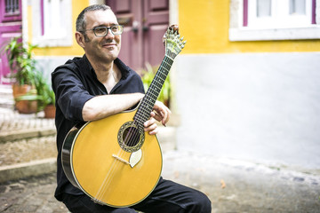 Wall Mural - Musician with his beloved unique portuguese guitar, Portugal