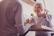 © Viacheslav Yakobchuk - Warm smile. Senior cute sociable woman spending time with her girlfriend smiling and eating.