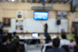 © Thammasiri - Abstract blur people lecture in seminar room, education or training concept.