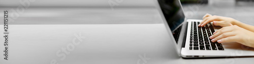 Fotografía Banner of laptop and female hands with copyspace in grey color background