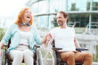 © Viacheslav Yakobchuk - Having fun together. Extremely happy mature couple getting exited while driving their wheelchairs and holding balloons outdoors.