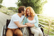 © Viacheslav Yakobchuk - Never bored together. Joyful disabled people looking at each other and smiling cheerfully while enjoying a pleasant conversation outdoors.