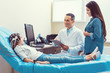 © Viacheslav Yakobchuk - How do you feel. Friendly mature medical professional and mindful parent smiling to a poor little girl undergoing electroencephalography analysis in a lab.
