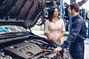 Wall Mural - Auto car repair service center. The mechanic communicates with the client